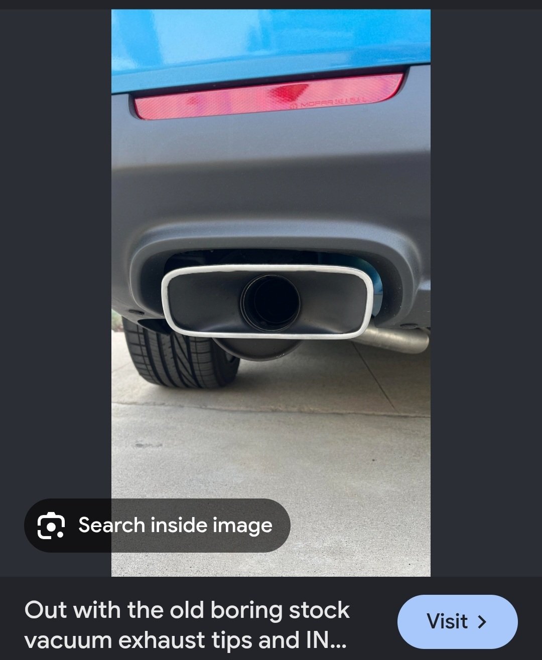 Reference photo of a stock Dodge Challenger exhaust tip: a single rectangular chrome surround with one round pipe inside, the stock vacuum-style tip.