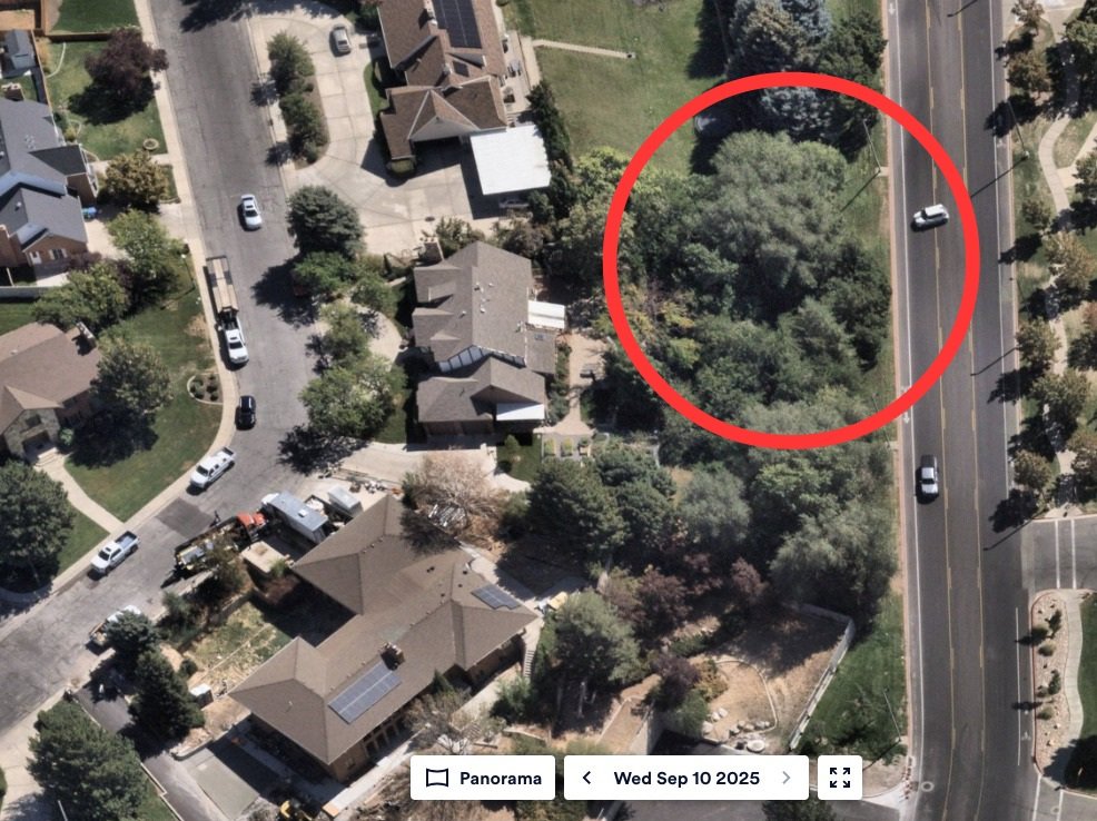 Aerial imagery dated Wed Sep 10 2025 with a red circle drawn around a wooded lot between a residential street and a four-lane road north of the UVU campus.