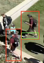Overhead still of a UVU sidewalk on September 10, 2025: two men boxed in red, each in a burgundy T-shirt, shorts, black backpack and cap