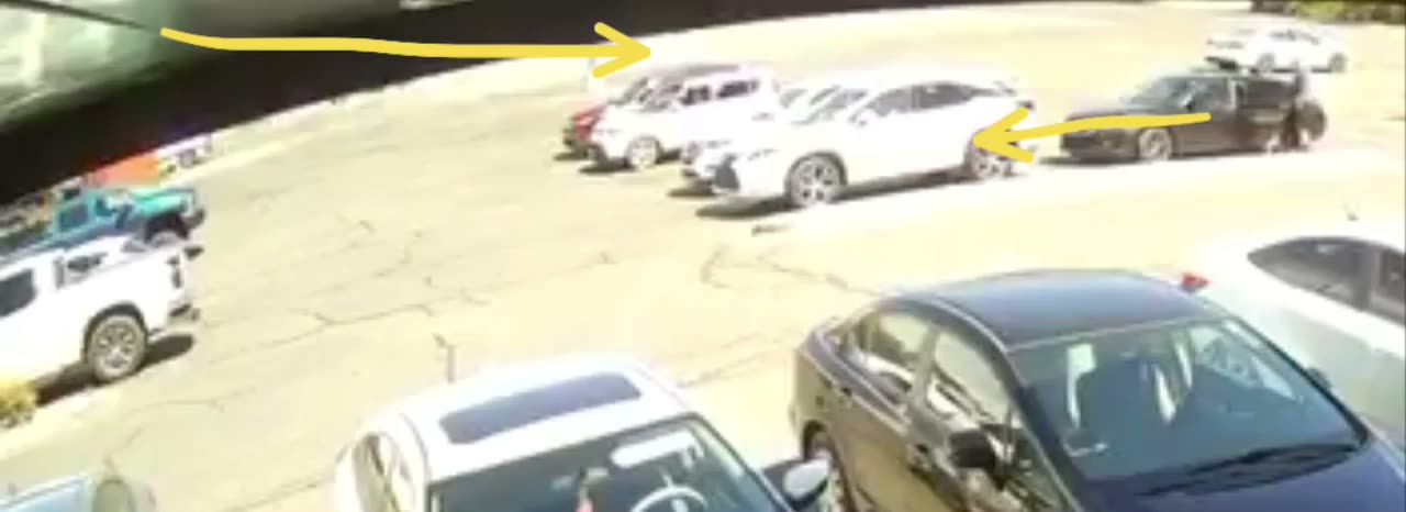 Parking-Lot Surveillance With Two Arrows Drawn On It